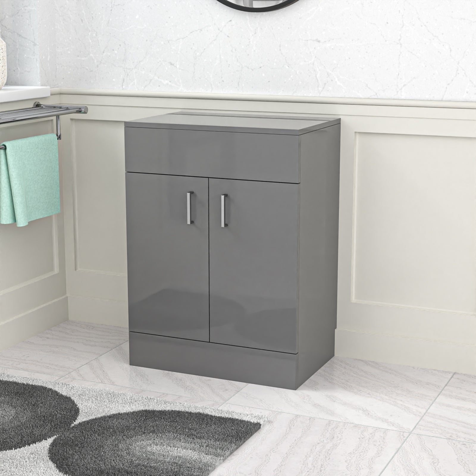 Gray cabinet in a bathroom setting with a towel and rug.