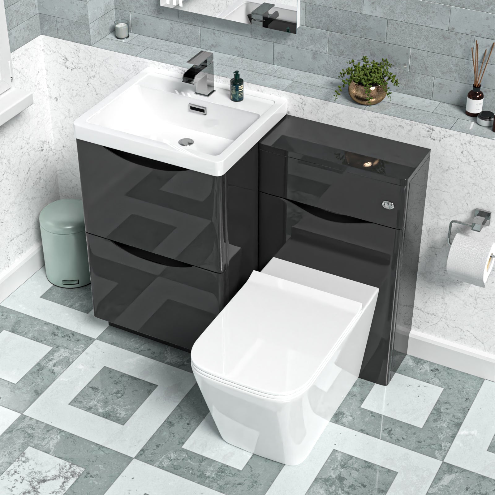 Bathroom setup with black vanity unit, white sink, and toilet against a tiled wall.