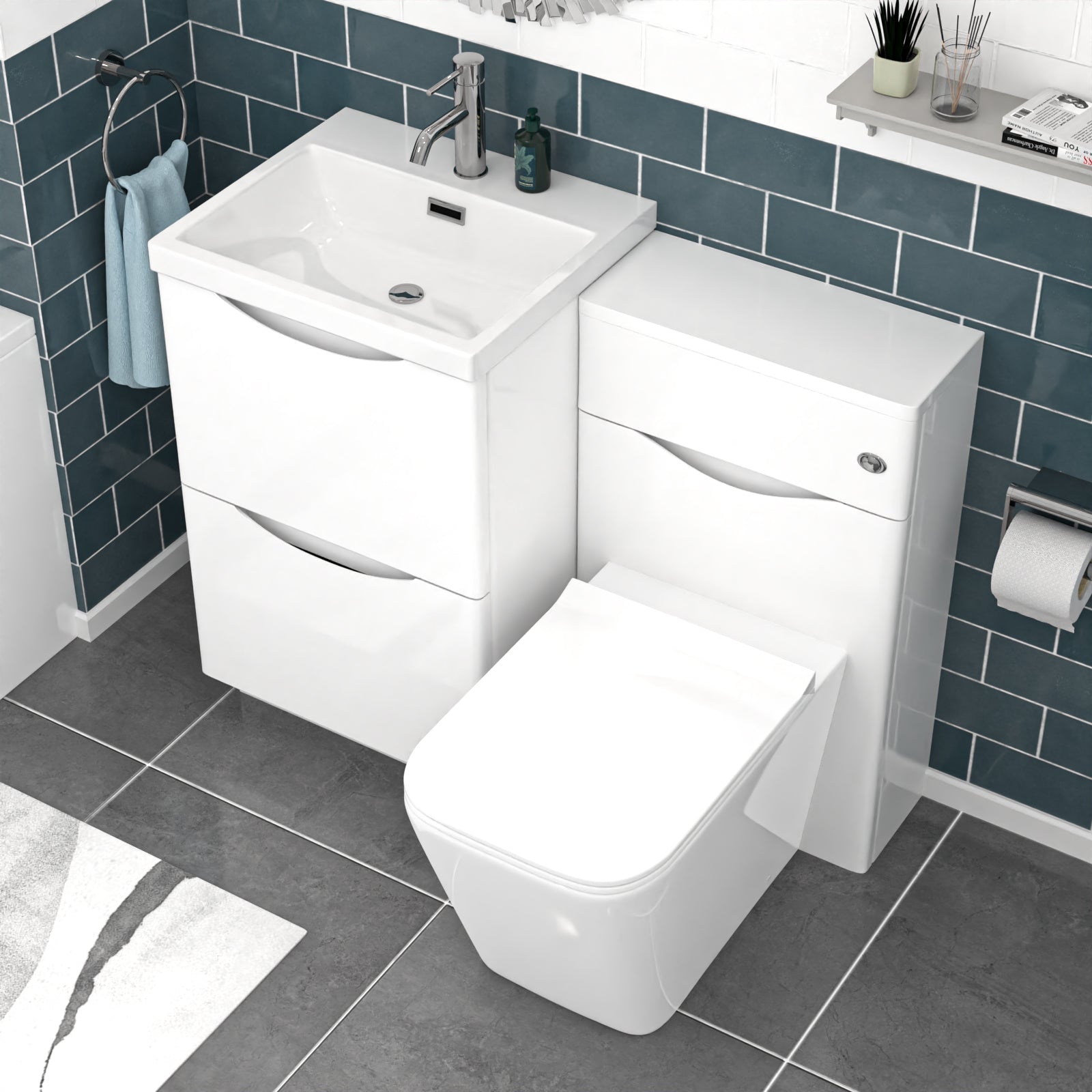 Bathroom setup with white vanity unit, sink, and toilet against a blue tiled wall.