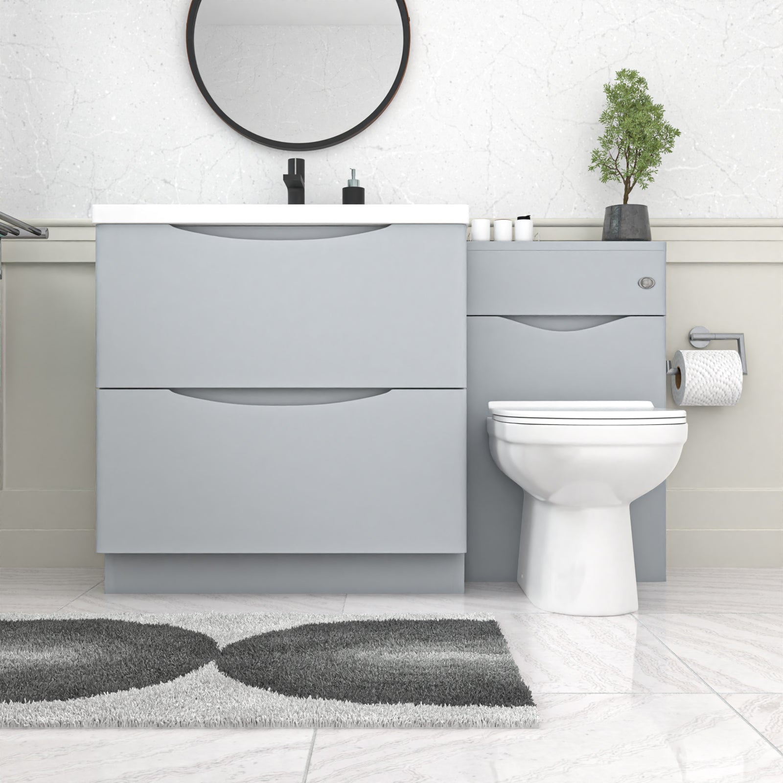 Bathroom setup with gray vanity unit, white toilet, and round mirror 