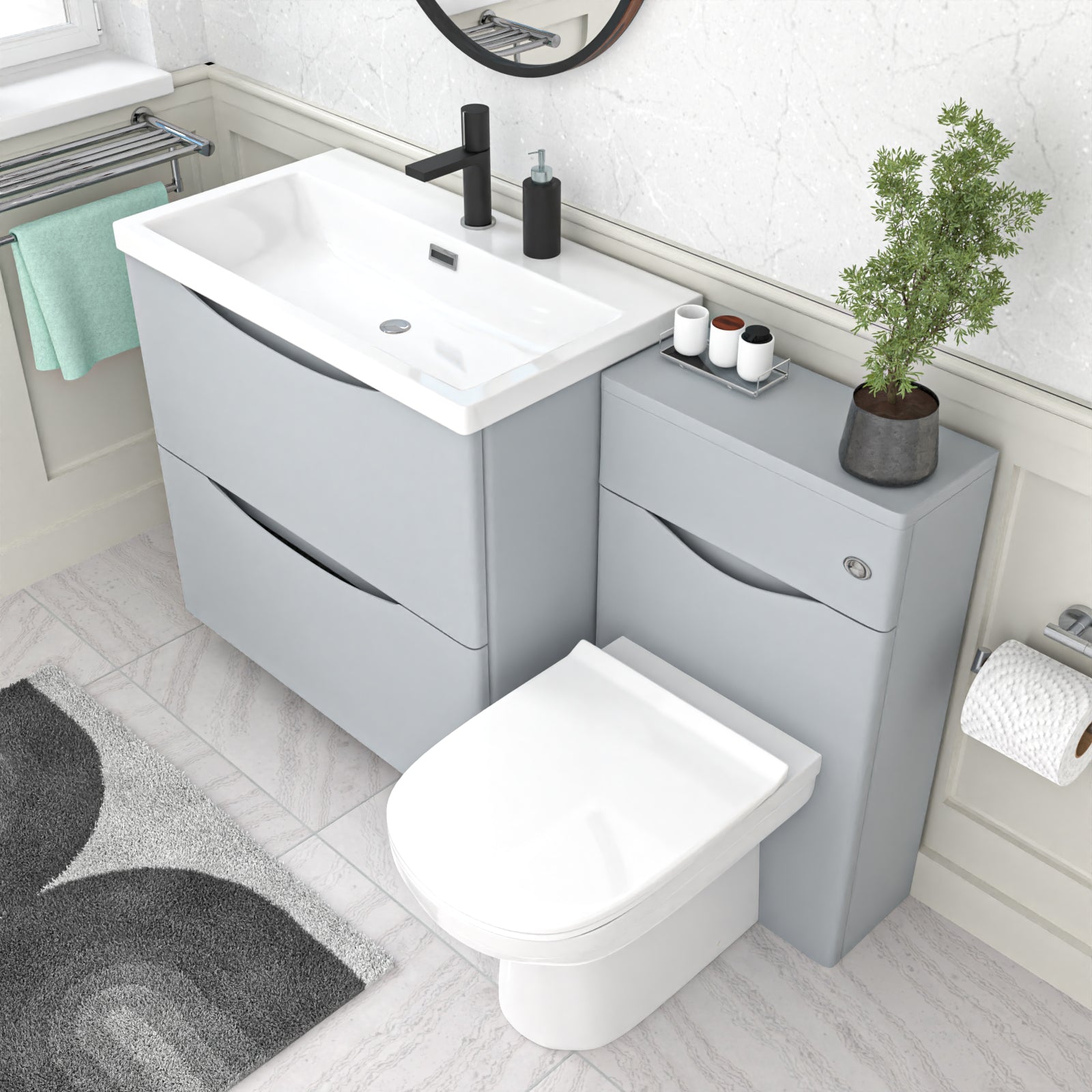 Bathroom setup with gray vanity unit, white toilet, and sink.