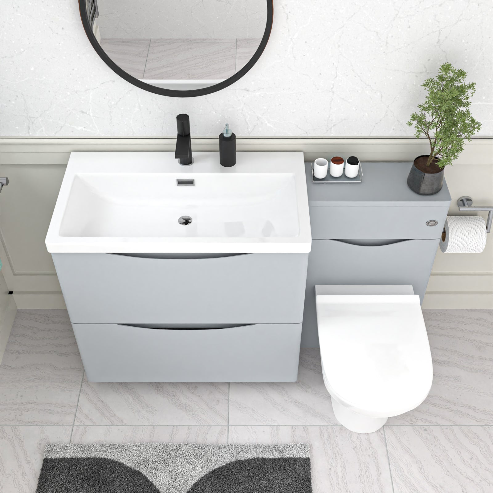 Bathroom setup with white vanity unit, toilet, and round mirror 