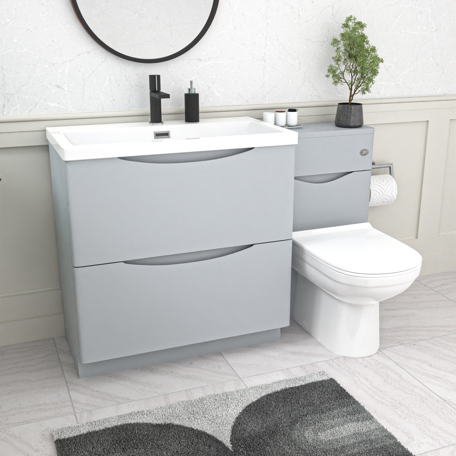 Bathroom setup with gray vanity unit, white toilet, and sink.