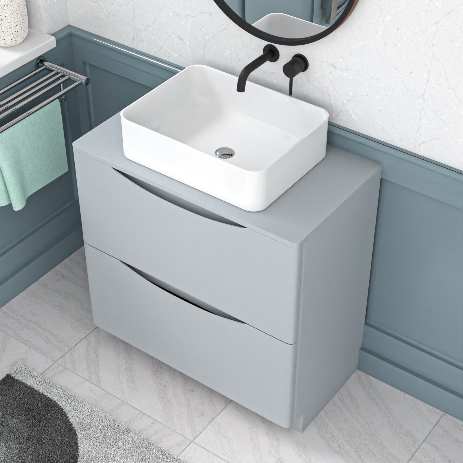 Bathroom vanity with white sink and gray cabinet against a light blue wall.