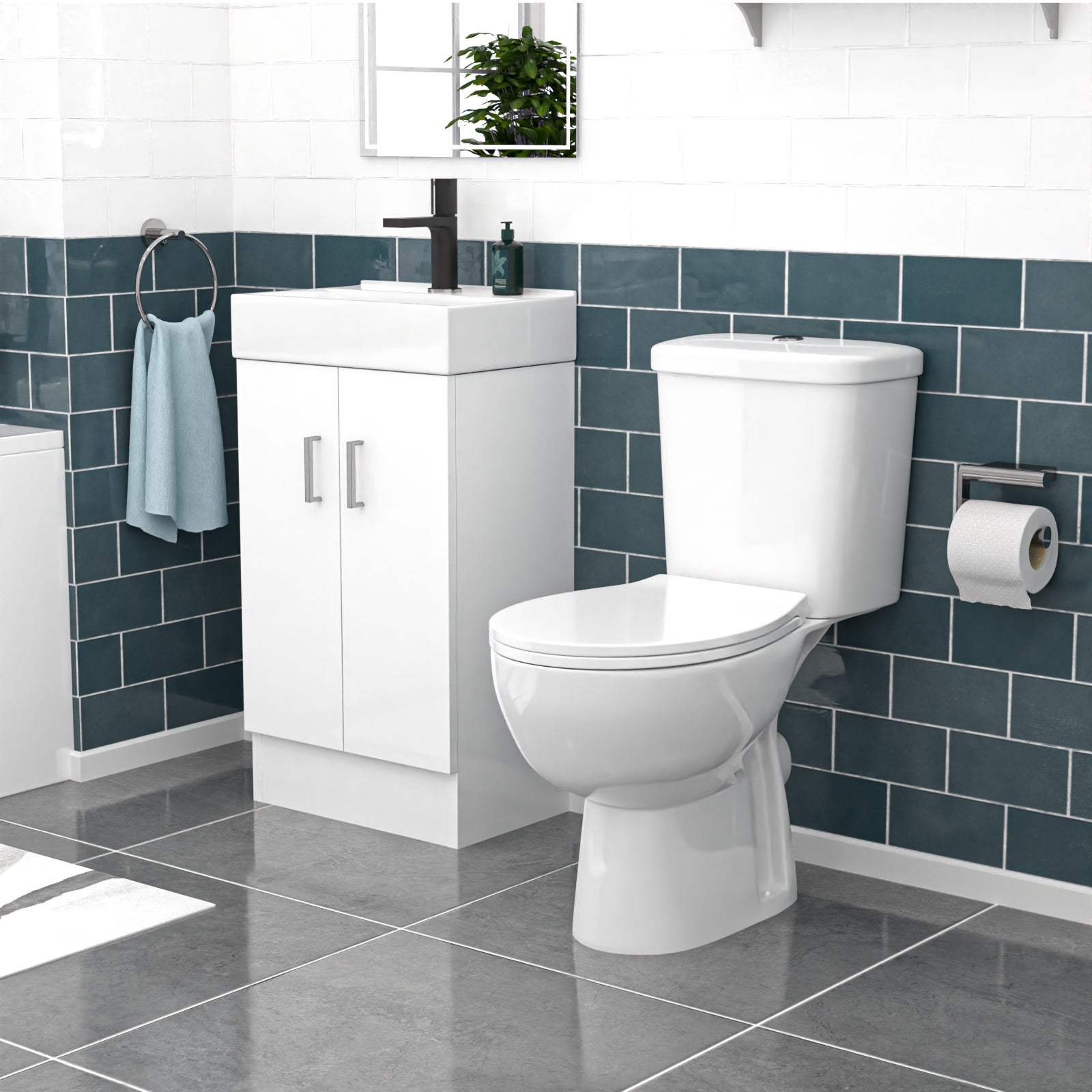 Bathroom setup with white toilet, sink, and cabinet against a blue tiled wall.