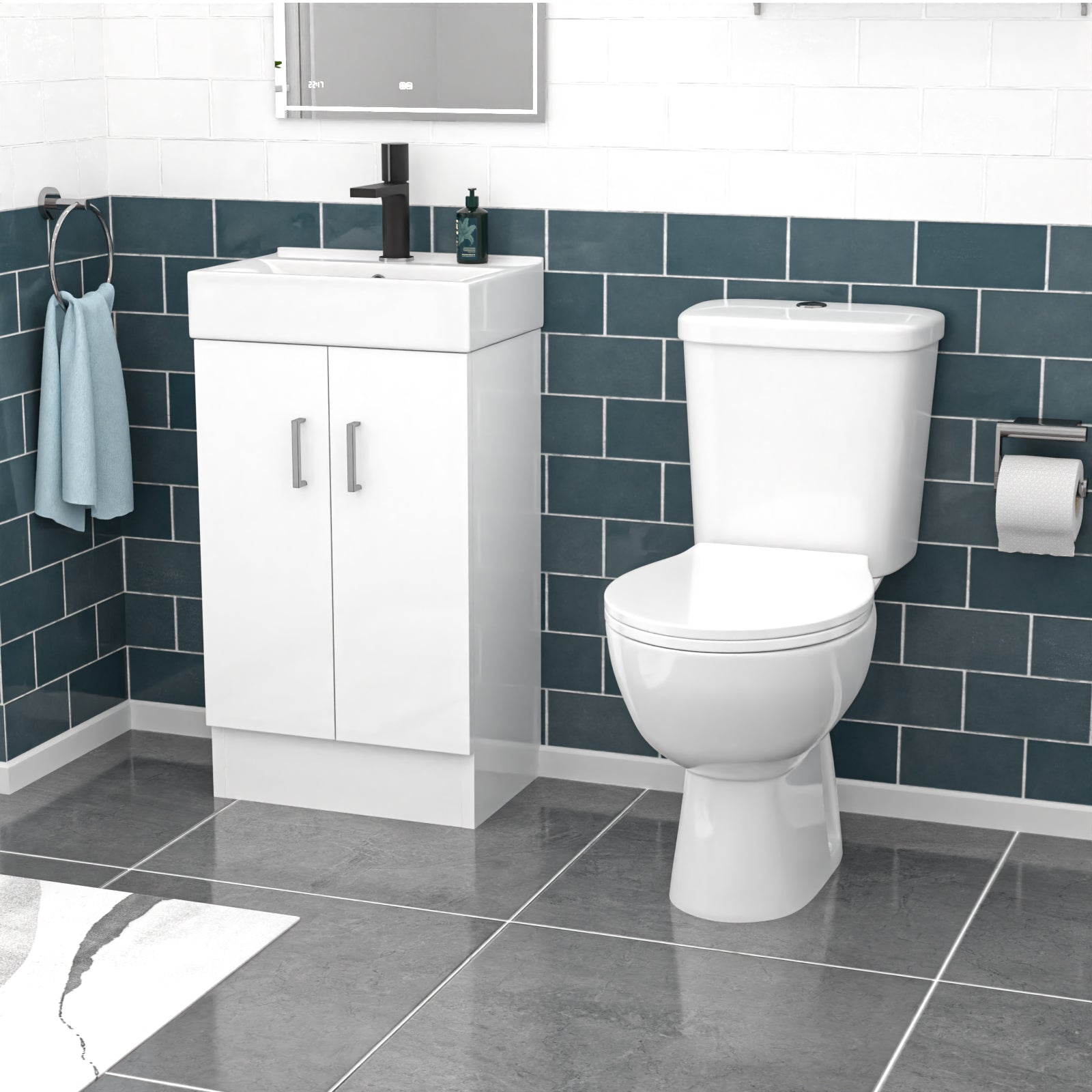 Bathroom setup with white toilet and vanity unit against a blue tiled wall.