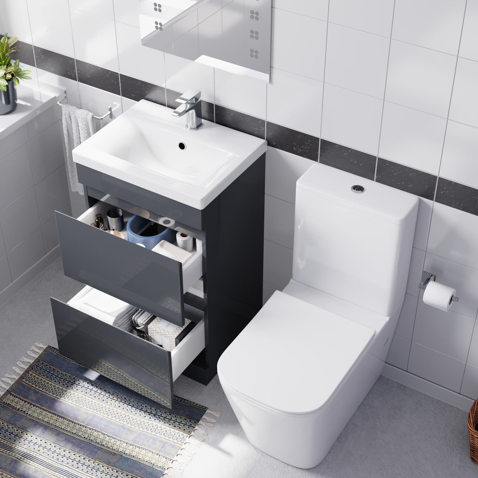 Bathroom setup with a vanity unit and toilet in a tiled bathroom.