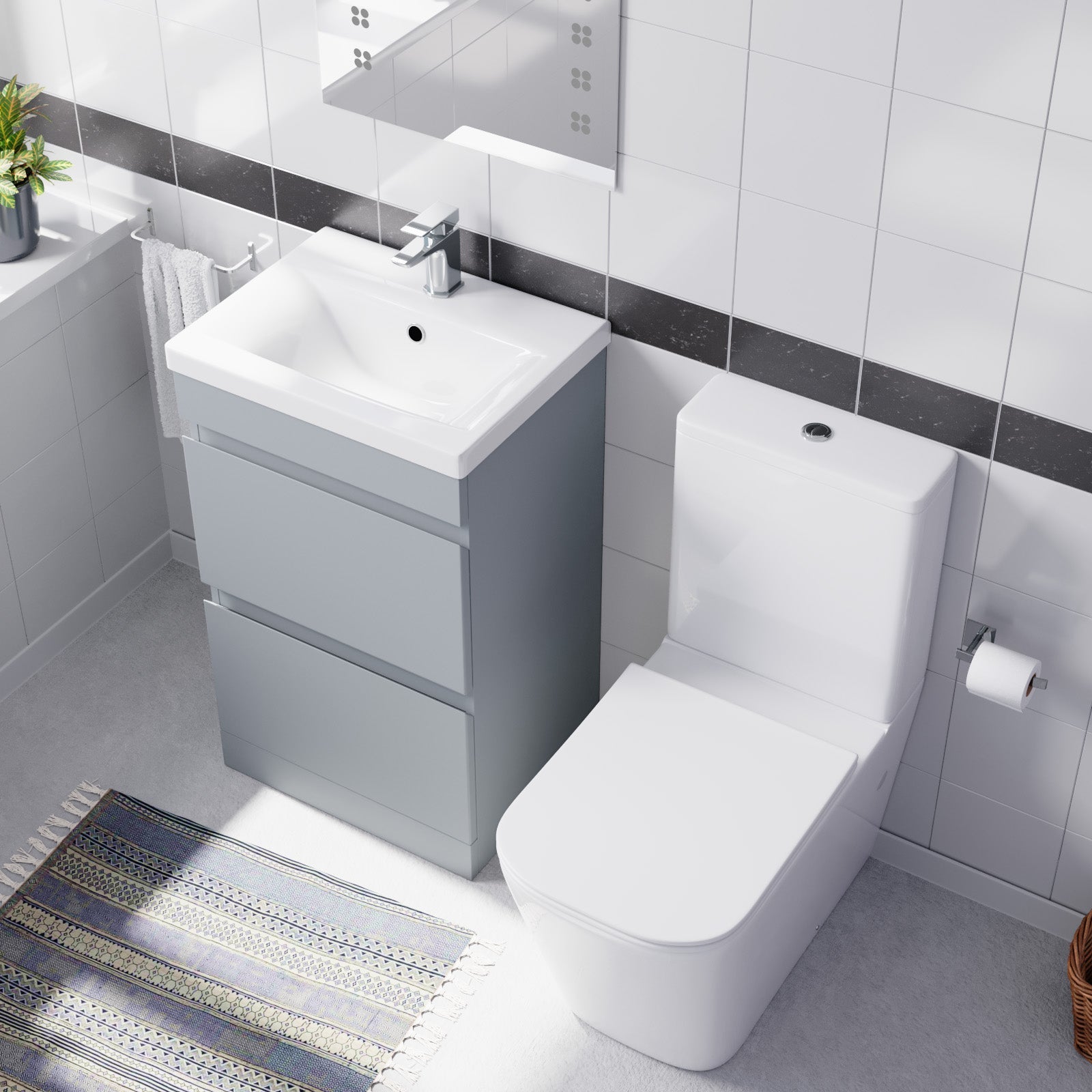 modern low space bathroom with white toilet and sink vanity 