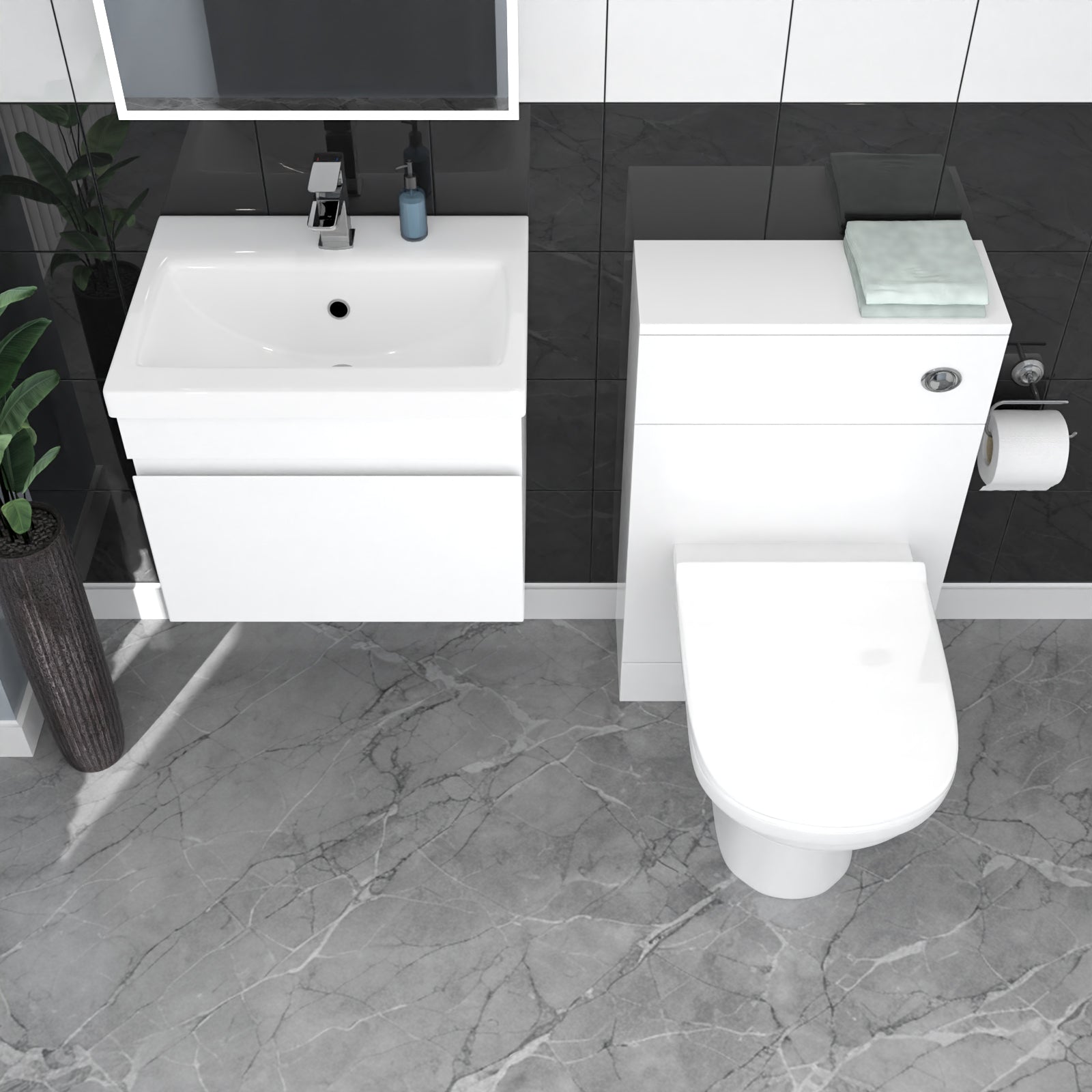 Bathroom setup with white vanity, sink, and toilet against a black tiled wall.