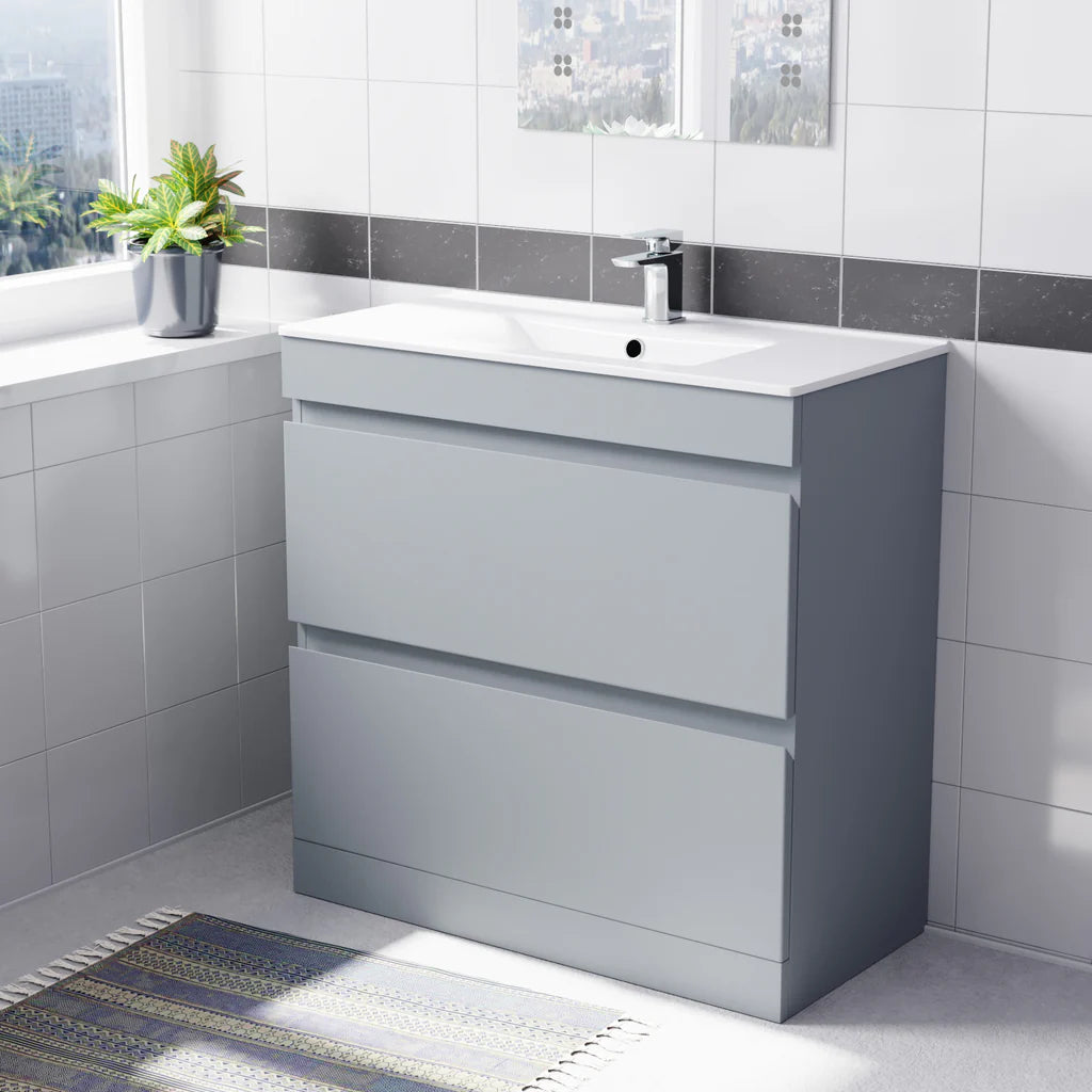Gray vanity unit with white sink in a bathroom setting