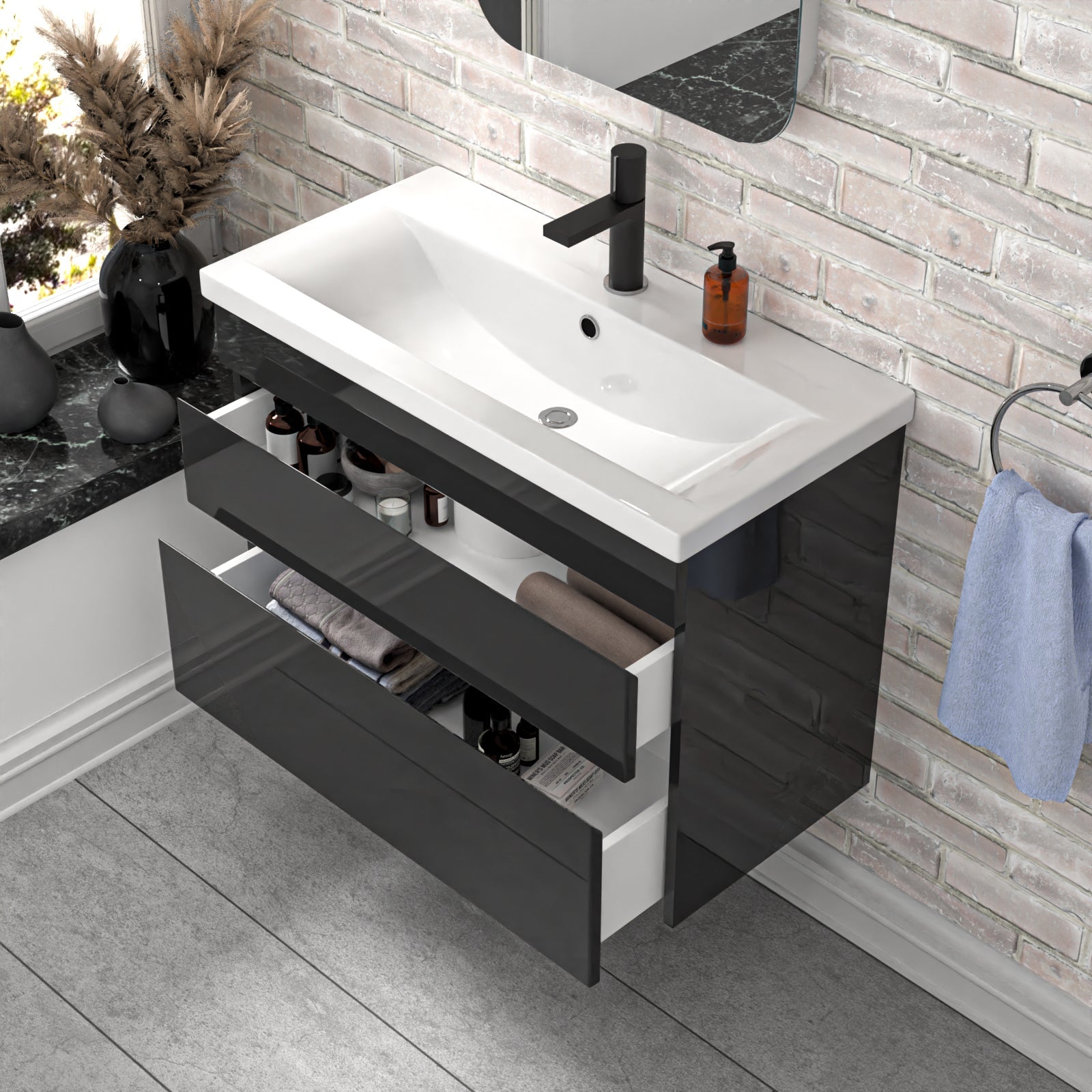 Bathroom vanity with white sink and black drawers in a modern bathroom setting.