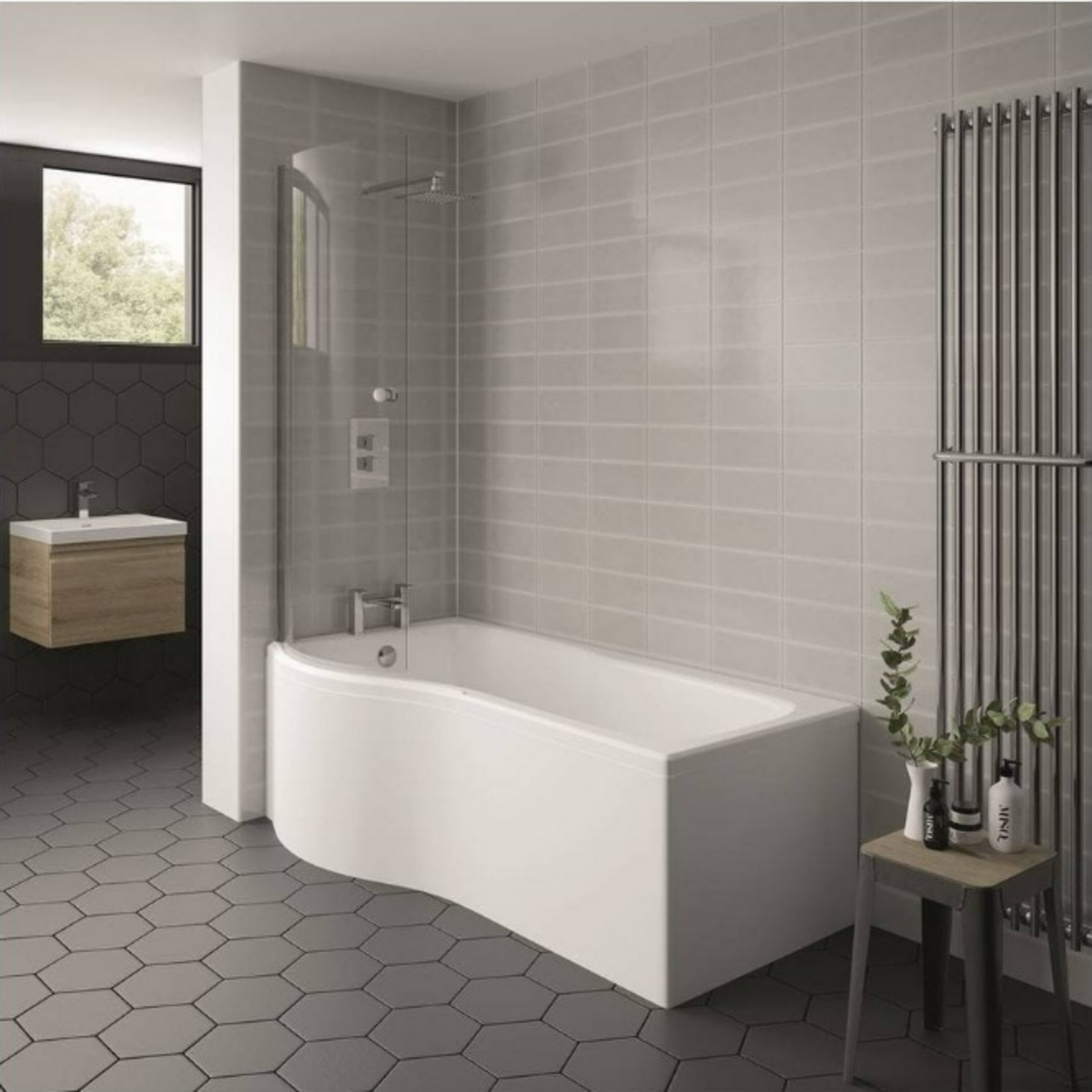Modern bathroom with a white freestanding bathtub, gray tiled walls, and hexagonal floor tiles.