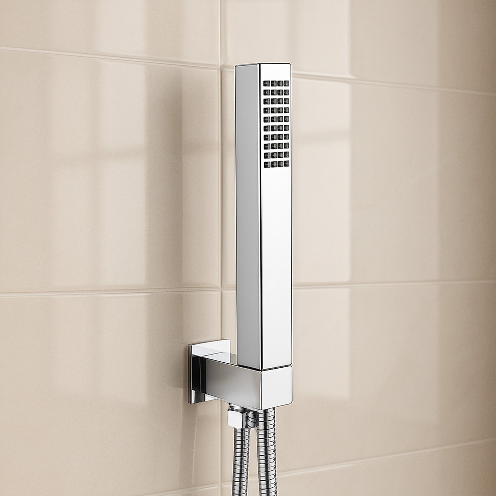 Chrome shower head mounted on a tiled wall
