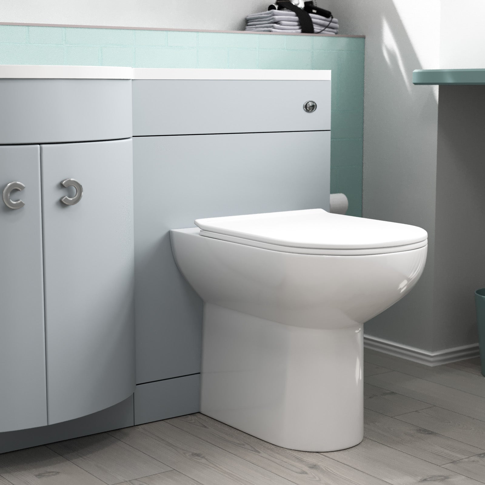 White toilet in a bathroom with gray cabinets