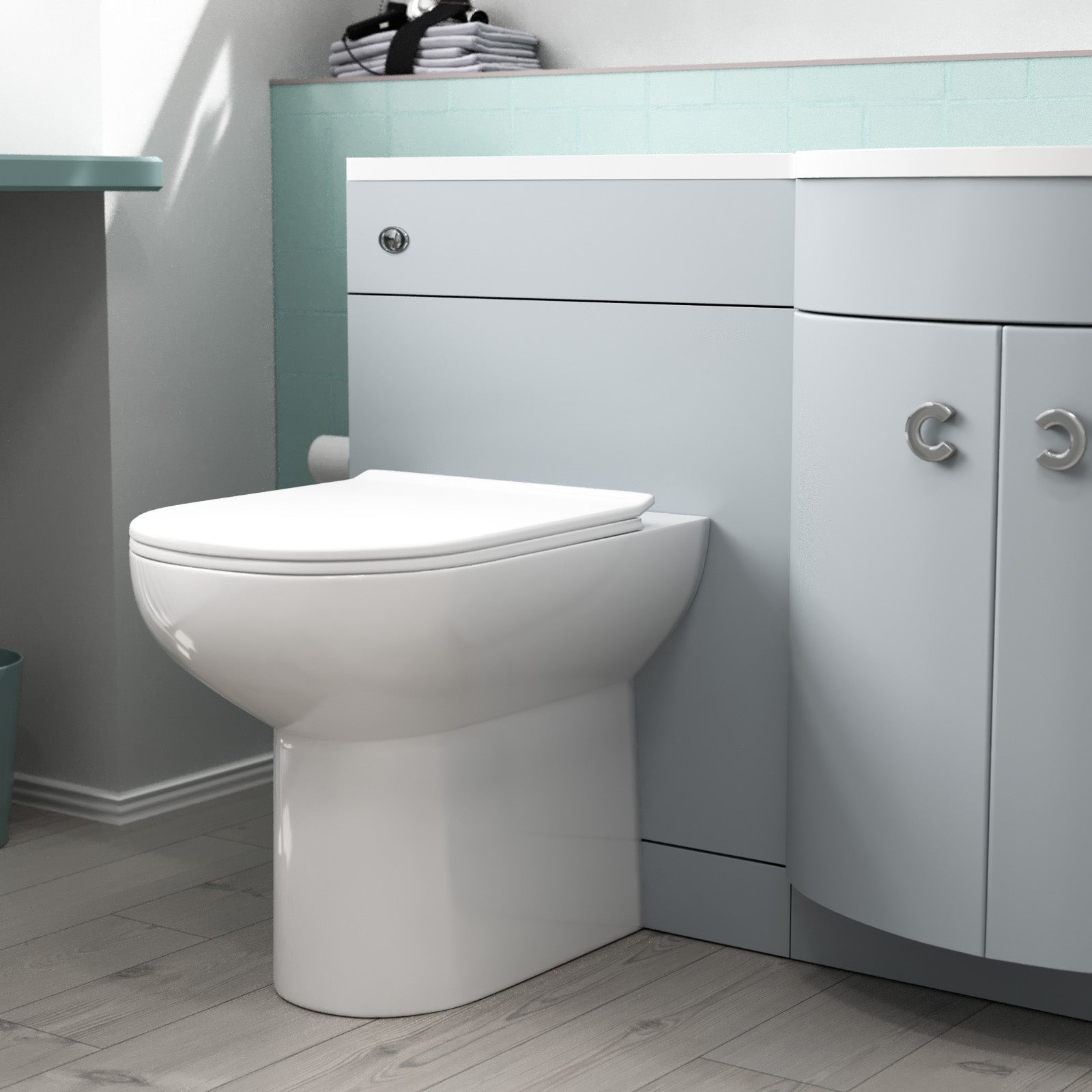 White toilet in a bathroom with gray cabinets