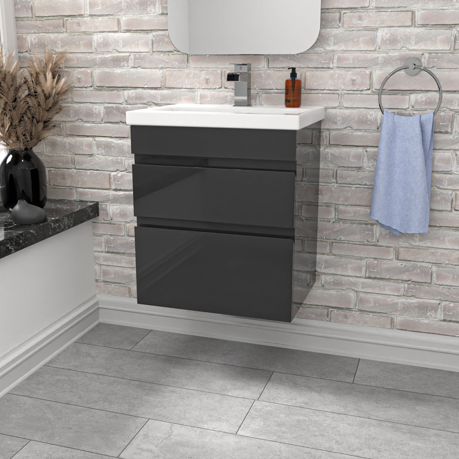 Bathroom vanity with dark gray cabinet, white countertop, and light gray tiled wall.