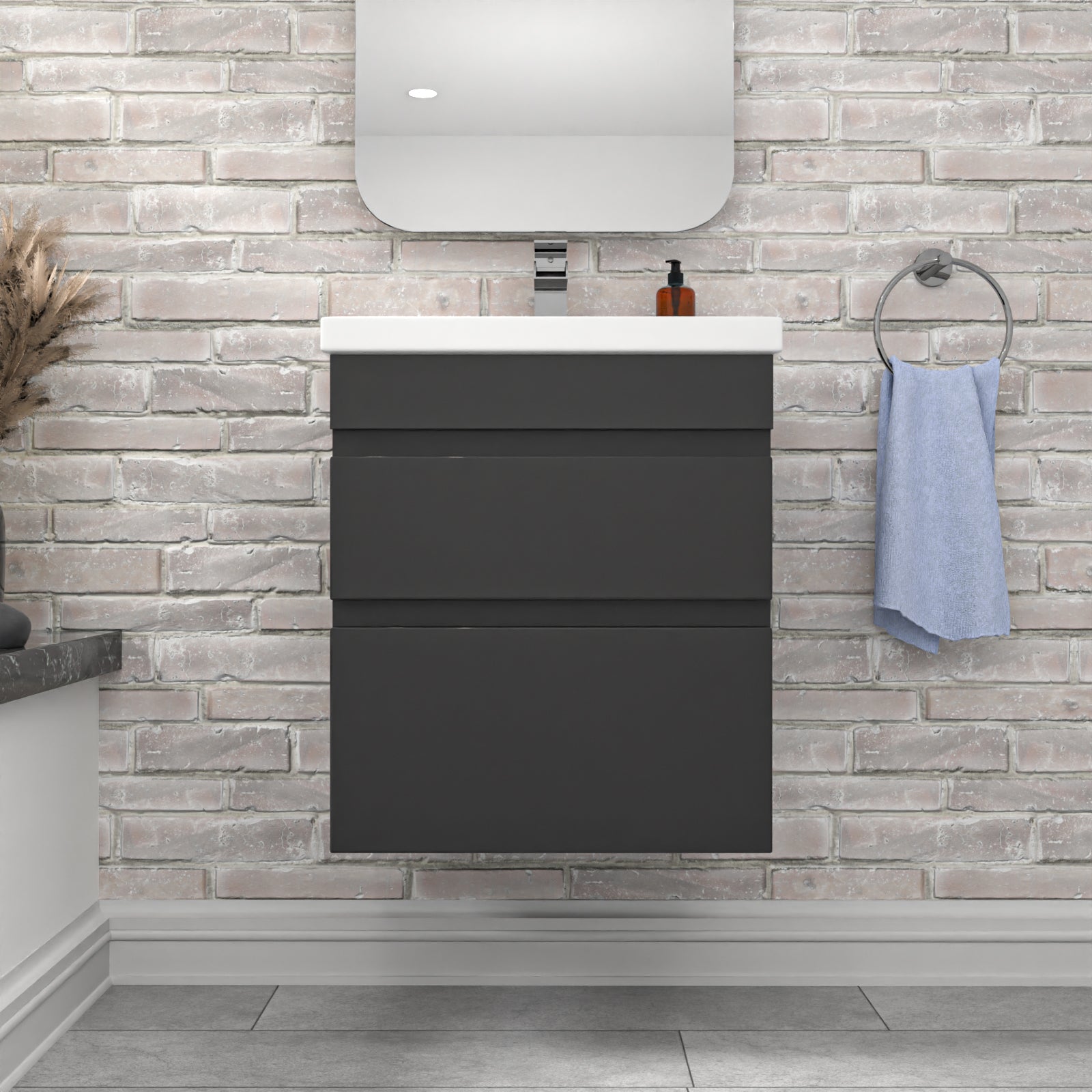 Bathroom vanity with dark cabinet, white countertop, and towel hanging on a brick wall.
