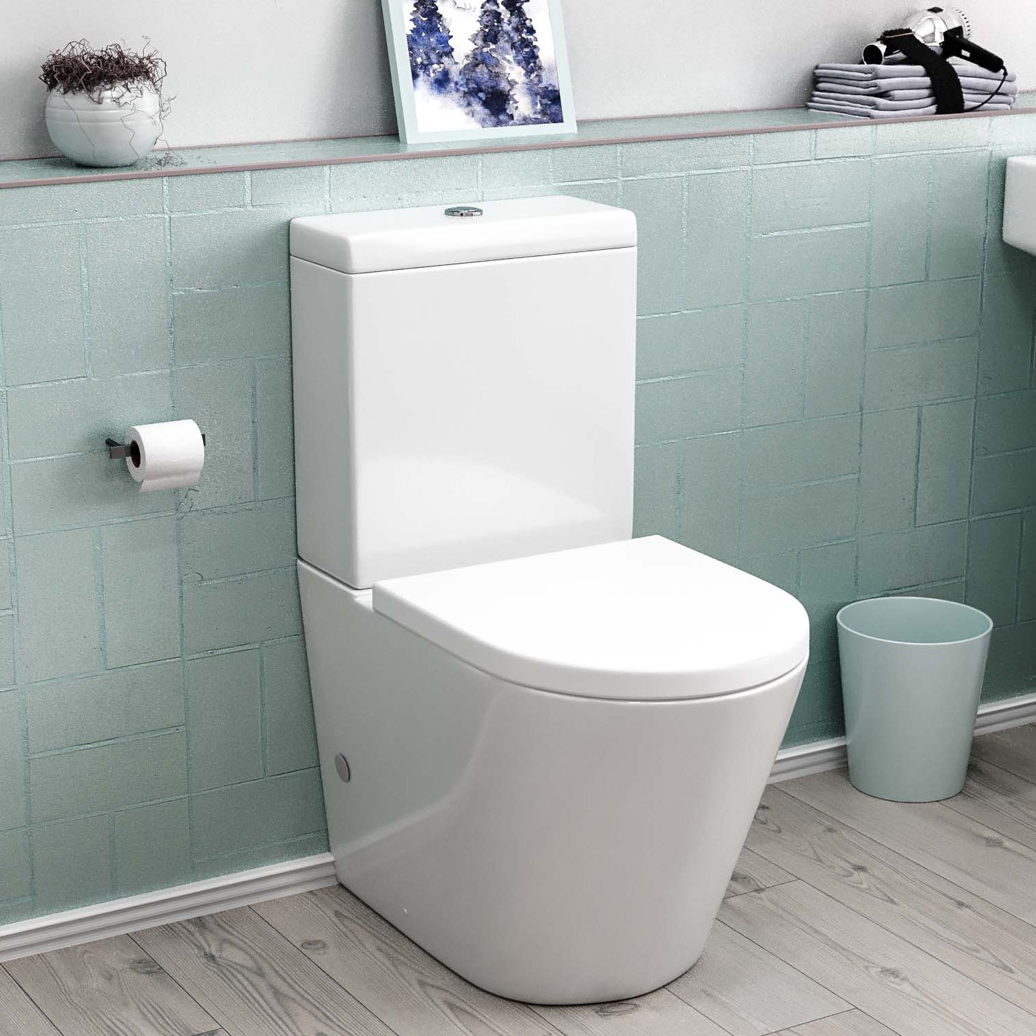 White toilet in a bathroom with light blue tiled walls and a trash can.
