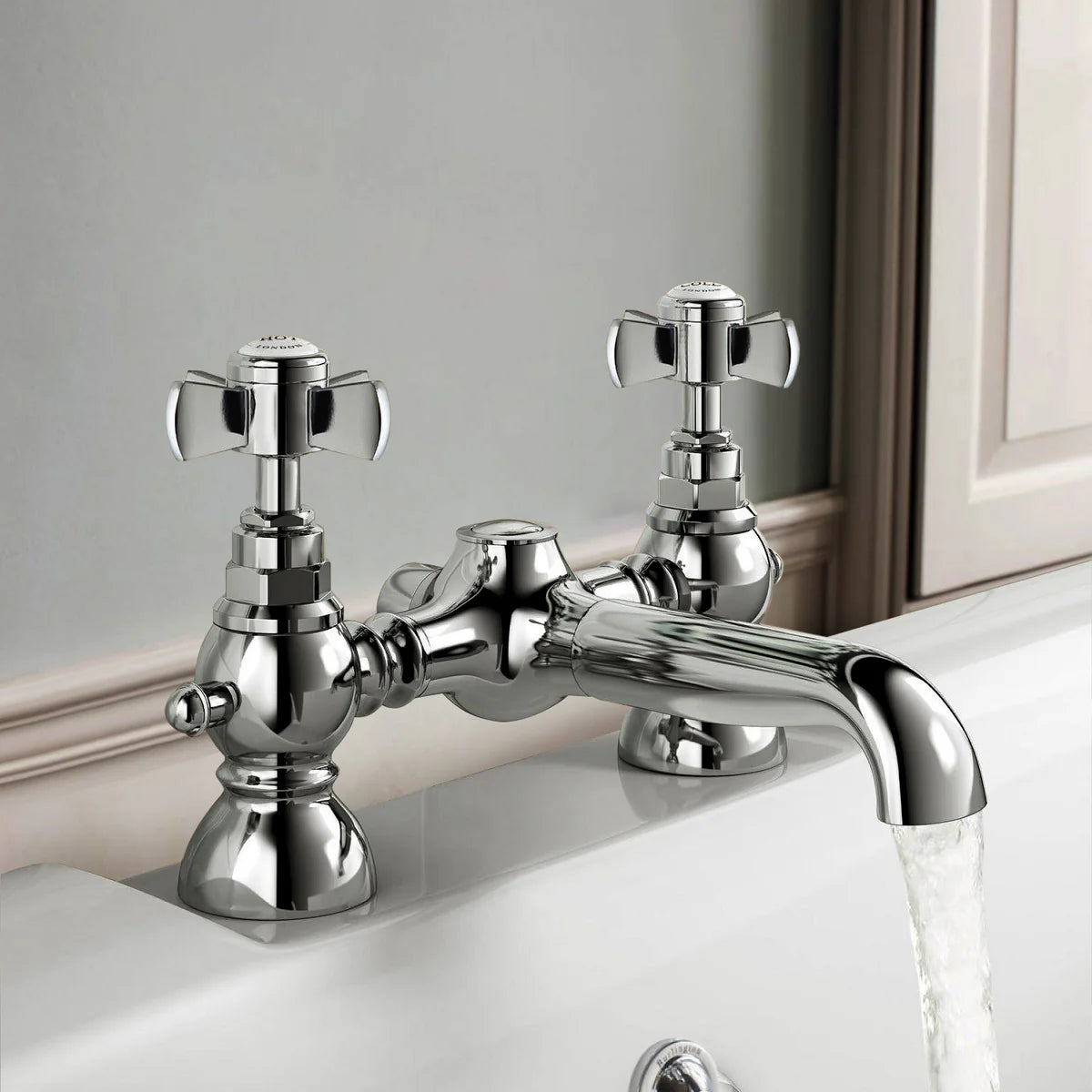 Chrome bathroom faucet on a sink with a neutral background
