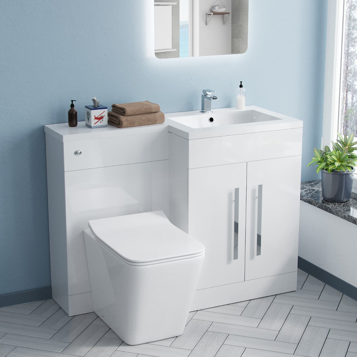 Bathroom setup with white vanity unit, toilet, and sink against a light blue wall.