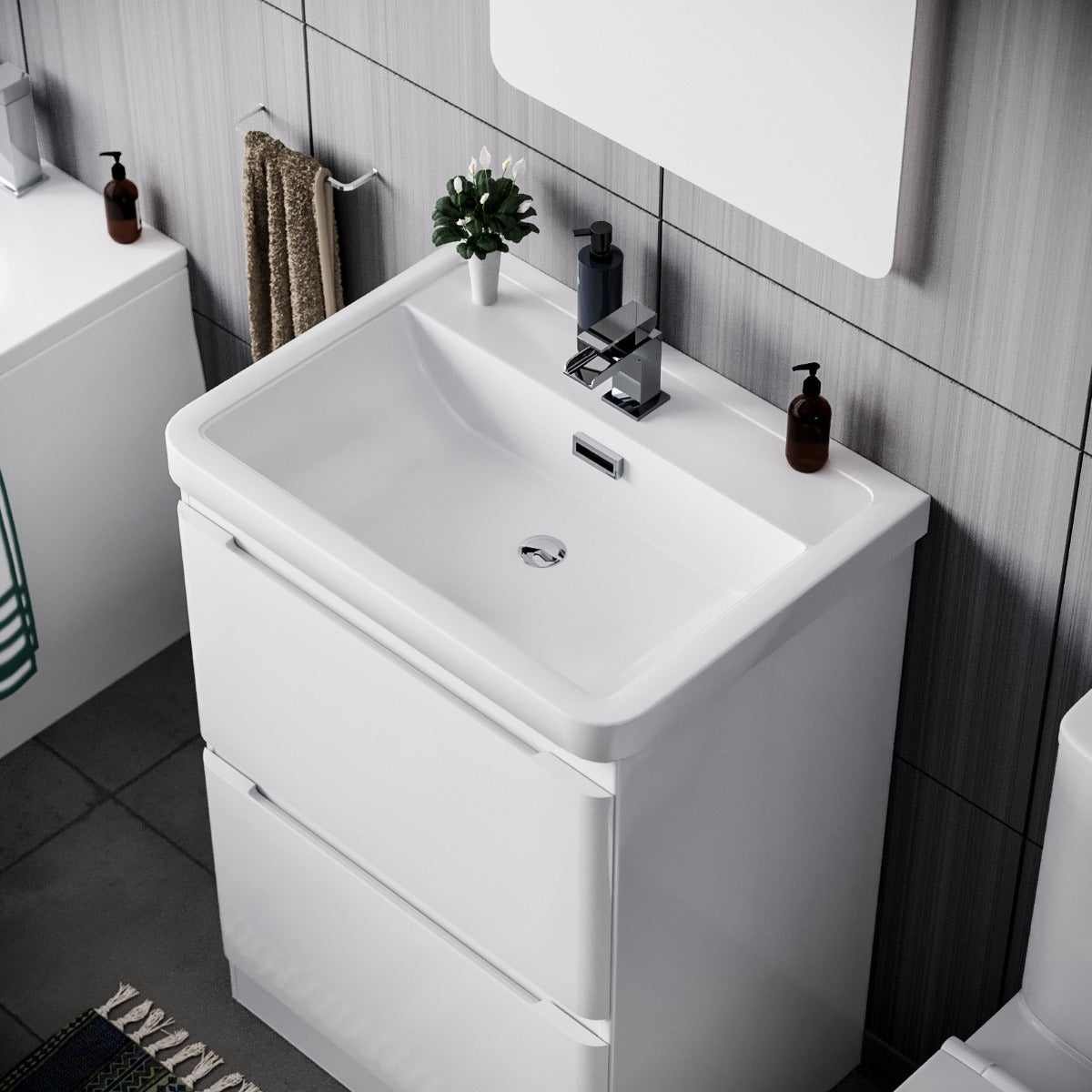 Bathroom vanity with sink and mirror in a tiled bathroom