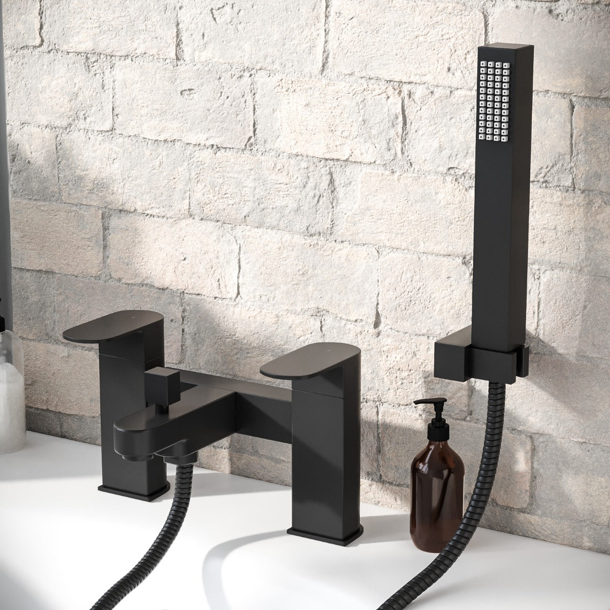 Black bathtub faucet and shower head set against a stone wall background