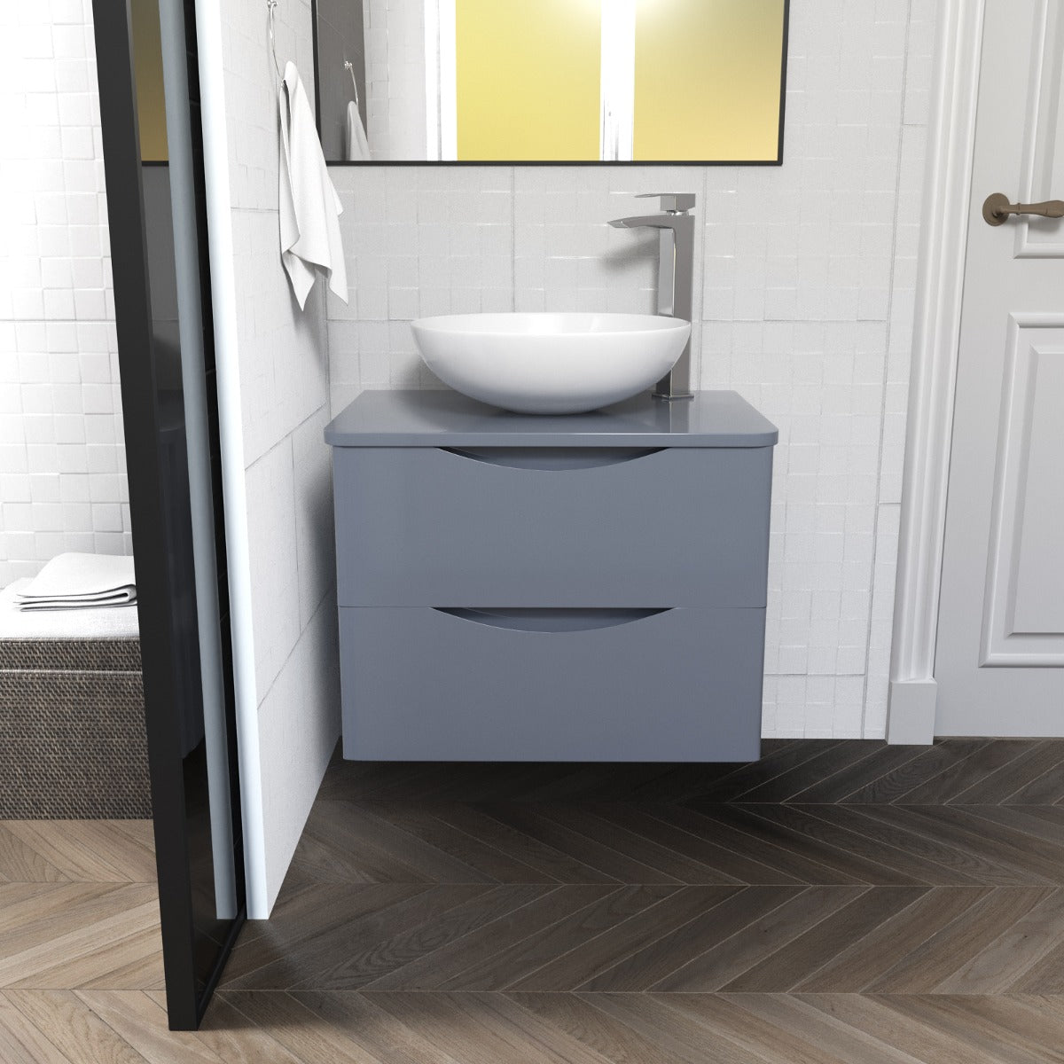 Bathroom vanity with a white sink and gray cabinet against a tiled wall.